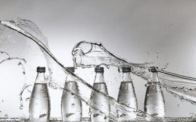 A group of bottles of water being filled with water